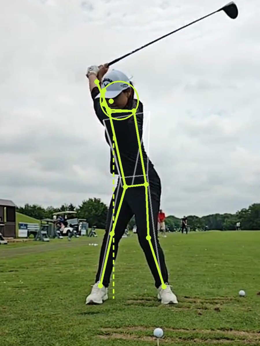 Golfer at the top of the backswing with pose tracking lines drawn on the body